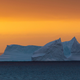 An Antarctic iceberg at sunset.
